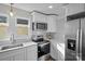 Bright kitchen with stainless appliances, quartz countertops, stylish backsplash and large windows at 691 Gibson Nw Dr, Concord, NC 28025