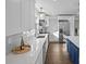 Bright, modern kitchen with white cabinets, stainless steel appliances, and hardwood floors at 691 Gibson Nw Dr, Concord, NC 28025
