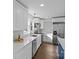 Bright, updated kitchen featuring white cabinets, stainless steel appliances and quartz countertops at 691 Gibson Nw Dr, Concord, NC 28025