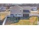 An aerial view of a large yard with a house, patio and privacy fence at 7436 Meridale Forest Dr, Charlotte, NC 28269