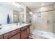 Bathroom with tiled walk-in shower, granite vanity, and a large framed mirror at 7436 Meridale Forest Dr, Charlotte, NC 28269