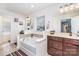 Bright bathroom featuring a soaking tub, double vanity, and neutral tile backsplash at 7436 Meridale Forest Dr, Charlotte, NC 28269