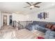 This room has plush carpeting, a ceiling fan, and a large gray sectional couch at 7436 Meridale Forest Dr, Charlotte, NC 28269