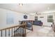 Spacious bonus room with plush carpeting, ceiling fan, and a large gray sectional couch at 7436 Meridale Forest Dr, Charlotte, NC 28269
