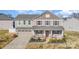 Charming two-story home featuring a cozy front porch, attached garage, and manicured landscaping at 7436 Meridale Forest Dr, Charlotte, NC 28269