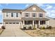 Inviting home showcasing a spacious front yard, attached garage and covered front porch at 7436 Meridale Forest Dr, Charlotte, NC 28269