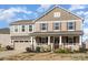 Charming two-story home featuring a welcoming front porch and well-maintained landscaping at 7436 Meridale Forest Dr, Charlotte, NC 28269