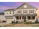 Charming two-story home featuring a welcoming front porch and well-maintained landscaping at 7436 Meridale Forest Dr, Charlotte, NC 28269