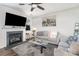 Cozy living room features a gray couch, fireplace, flat-screen television, and modern decor at 7436 Meridale Forest Dr, Charlotte, NC 28269