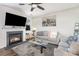 Cozy living room with a fireplace, comfortable seating, and natural light at 7436 Meridale Forest Dr, Charlotte, NC 28269