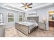 Main bedroom features a tray ceiling, ceiling fan, carpet flooring, and abundant natural light at 7436 Meridale Forest Dr, Charlotte, NC 28269