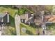 Aerial view of home showcasing roof, yard, driveway, and tree-lined property at 7510 Plumcrest Ln, Harrisburg, NC 28075