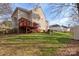 Spacious backyard with a deck, patio, fire pit, shed, and well-maintained lawn at 7510 Plumcrest Ln, Harrisburg, NC 28075