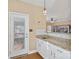 Granite bar area featuring white cabinets and easy access to the backyard deck space at 7510 Plumcrest Ln, Harrisburg, NC 28075