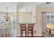 Breakfast bar with seating, leading to an open dining and kitchen space, perfect for casual dining at 7510 Plumcrest Ln, Harrisburg, NC 28075
