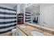 Bathroom featuring double sinks, granite countertops, decorative mirror, and striped shower curtain at 7510 Plumcrest Ln, Harrisburg, NC 28075