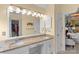 Bathroom with double vanity with granite countertops, framed mirror, linen cabinet at 7510 Plumcrest Ln, Harrisburg, NC 28075