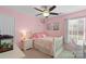 Cute bedroom features soft pink walls, with artwork and classic furniture, creating an inviting space at 7510 Plumcrest Ln, Harrisburg, NC 28075