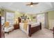 Bright bedroom features tray ceiling, neutral paint, windows, and furniture, creating an inviting space at 7510 Plumcrest Ln, Harrisburg, NC 28075