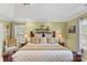 Bedroom boasts a large bed, tray ceilings, and neutral tones, creating a relaxing atmosphere at 7510 Plumcrest Ln, Harrisburg, NC 28075