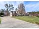 Spacious two-story home with brick and siding, long driveway, lush green lawn, and mature landscaping at 7510 Plumcrest Ln, Harrisburg, NC 28075