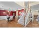 Inviting foyer featuring hardwood floors, staircase, and a view into the elegant dining area with a chandelier at 7510 Plumcrest Ln, Harrisburg, NC 28075