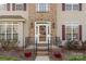 Close-up of front door with wreath, brick accents, sidelights, and charming curb appeal at 7510 Plumcrest Ln, Harrisburg, NC 28075