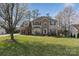 Inviting two-story home with brick and siding, a green lawn, and blossoming trees in a tranquil neighborhood at 7510 Plumcrest Ln, Harrisburg, NC 28075