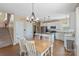 Bright kitchen featuring stainless steel appliances, granite counters, and a charming eat-in area at 7510 Plumcrest Ln, Harrisburg, NC 28075