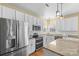 Updated kitchen boasts stainless appliances, granite counters, white cabinets and modern fixtures at 7510 Plumcrest Ln, Harrisburg, NC 28075