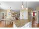 Open-concept design highlights the kitchen island, dining area, and cozy living space with fireplace at 7510 Plumcrest Ln, Harrisburg, NC 28075