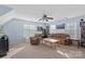 Bright living room with plush seating, ceiling fan, and natural light from multiple windows at 7510 Plumcrest Ln, Harrisburg, NC 28075