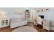 Cozy office space featuring a sofa, desk, and built-in bookcase, bathed in natural light from the window at 7510 Plumcrest Ln, Harrisburg, NC 28075