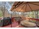Outdoor deck with ample seating under a large canopy, complete with grill and dining area at 7510 Plumcrest Ln, Harrisburg, NC 28075
