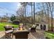 Cozy outdoor patio featuring a fire pit and comfortable seating, surrounded by lush landscaping at 7510 Plumcrest Ln, Harrisburg, NC 28075
