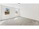 Bedroom with soft carpet, neutral walls, and windows with backyard views at 771 E Maurice St, Monroe, NC 28112