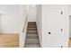 Carpeted staircase leading to the upper level with wooden handrail at 771 E Maurice St, Monroe, NC 28112