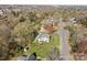 Aerial view of a home with a big yard nestled among trees in a residential neighborhood at 9218 Robert Burns Ct, Charlotte, NC 28213