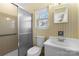 Bathroom features a shower, toilet, sink with mirror, and window at 9218 Robert Burns Ct, Charlotte, NC 28213