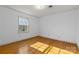 Sunlit bedroom with hardwood floors and a large window at 9218 Robert Burns Ct, Charlotte, NC 28213