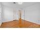 Spacious bedroom with hardwood floors, neutral walls, and two windows at 9218 Robert Burns Ct, Charlotte, NC 28213