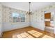 Traditional dining room with hardwood floors, floral wallpaper, and window with natural light at 9218 Robert Burns Ct, Charlotte, NC 28213