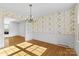 Bright dining area with hardwood floors, vintage chandelier and access to other rooms at 9218 Robert Burns Ct, Charlotte, NC 28213