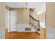 Inviting entryway with hardwood floors, traditional wallpaper, and staircase to the upper level at 9218 Robert Burns Ct, Charlotte, NC 28213