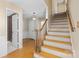 Hallway with wooden stairs, providing access to the upper levels of the house at 9218 Robert Burns Ct, Charlotte, NC 28213