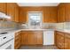Charming kitchen with wood cabinets, white appliances, and a view to the backyard at 9218 Robert Burns Ct, Charlotte, NC 28213