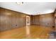 Classic living room with wood paneling, built-in shelving, and a cozy fireplace at 9218 Robert Burns Ct, Charlotte, NC 28213