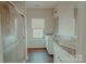 Bathroom featuring granite counters, double sinks, and tiled walk-in shower at 945 3Rd Street Sw Pl, Hickory, NC 28602