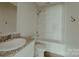 Modern bathroom with granite counters, white cabinets, and a clean, updated shower-tub combo at 945 3Rd Street Sw Pl, Hickory, NC 28602