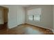 Bedroom with hardwood floors, a closet, and a window overlooking the neighborhood at 945 3Rd Street Sw Pl, Hickory, NC 28602